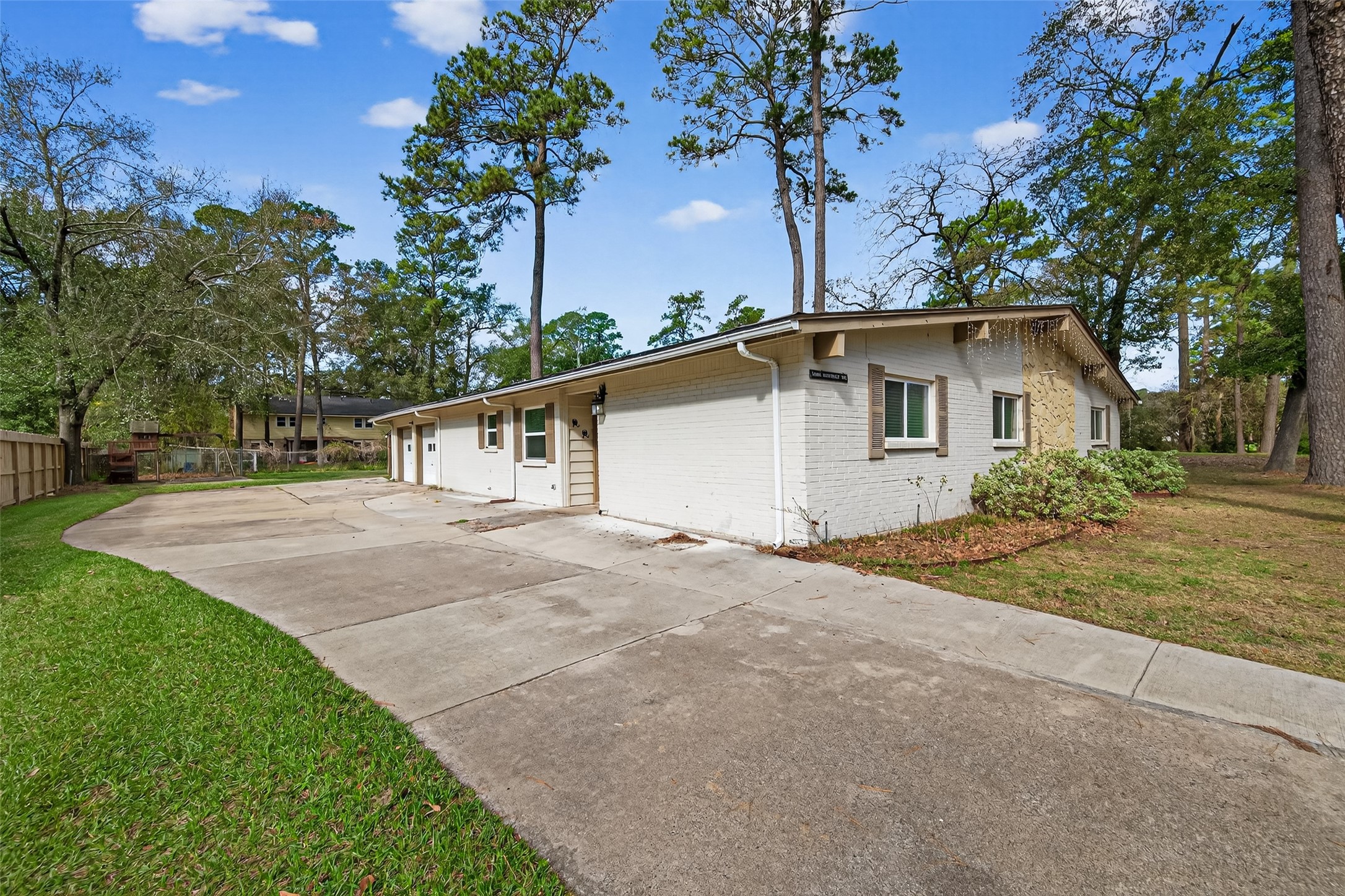 11811 Beverly Drive Houston, TX 77065 - Photo 3 of 48 a view of a house with a yard and garage