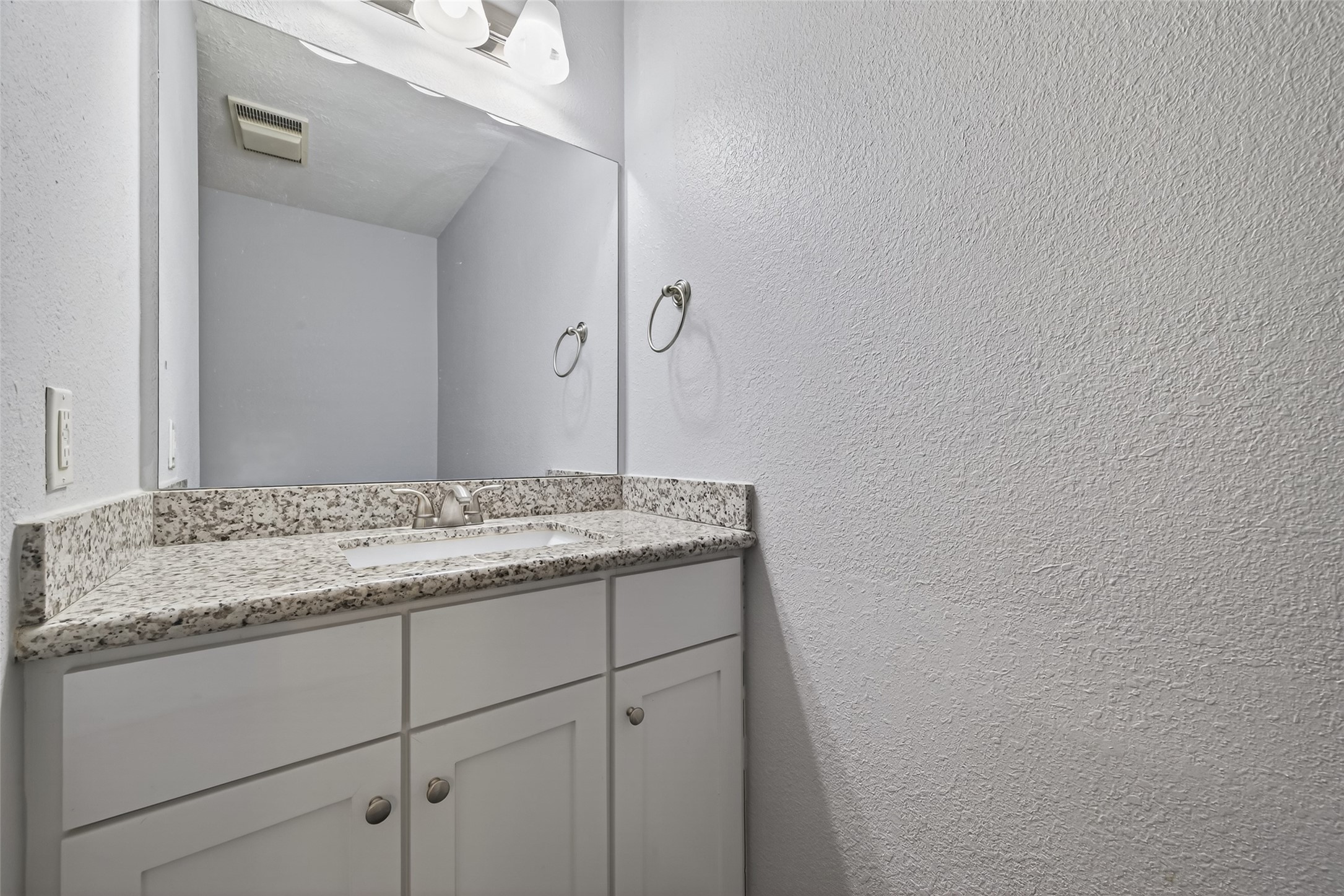 11811 Beverly Drive Houston, TX 77065 - Photo 32 of 48 a bathroom with a granite countertop sink and a mirror
