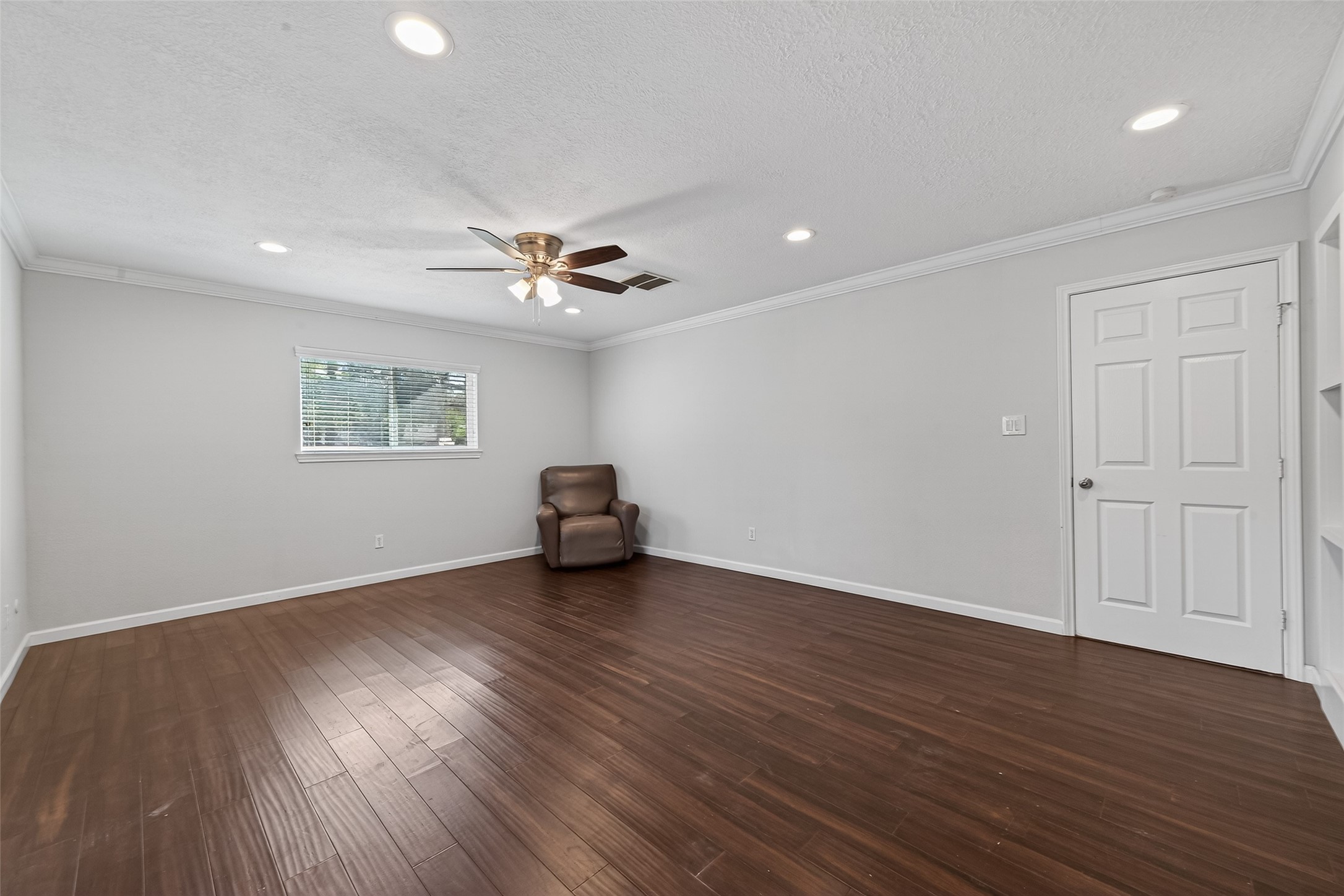 11811 Beverly Drive Houston, TX 77065 - Photo 36 of 48 a view of an empty room with a window and wooden floor