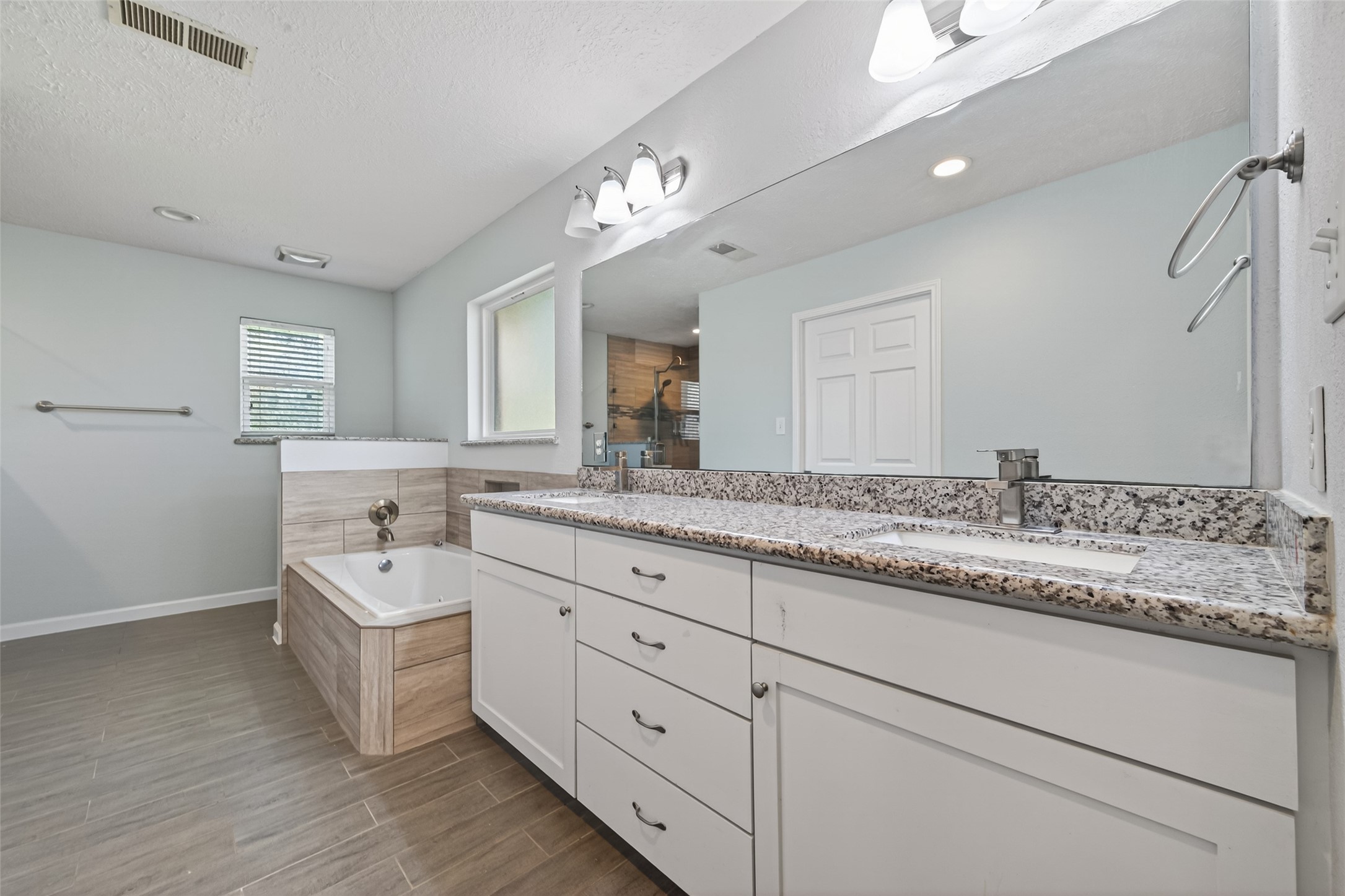 11811 Beverly Drive Houston, TX 77065 - Photo 39 of 48 a bathroom with a granite countertop double vanity sink and mirror