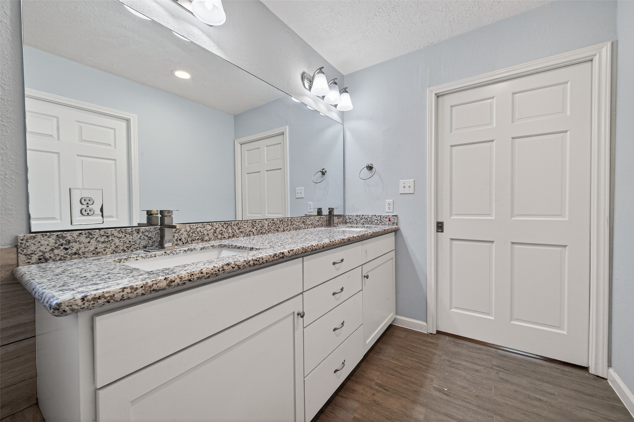 11811 Beverly Drive Houston, TX 77065 - Photo 40 of 48 a bathroom with a granite countertop sink and a mirror