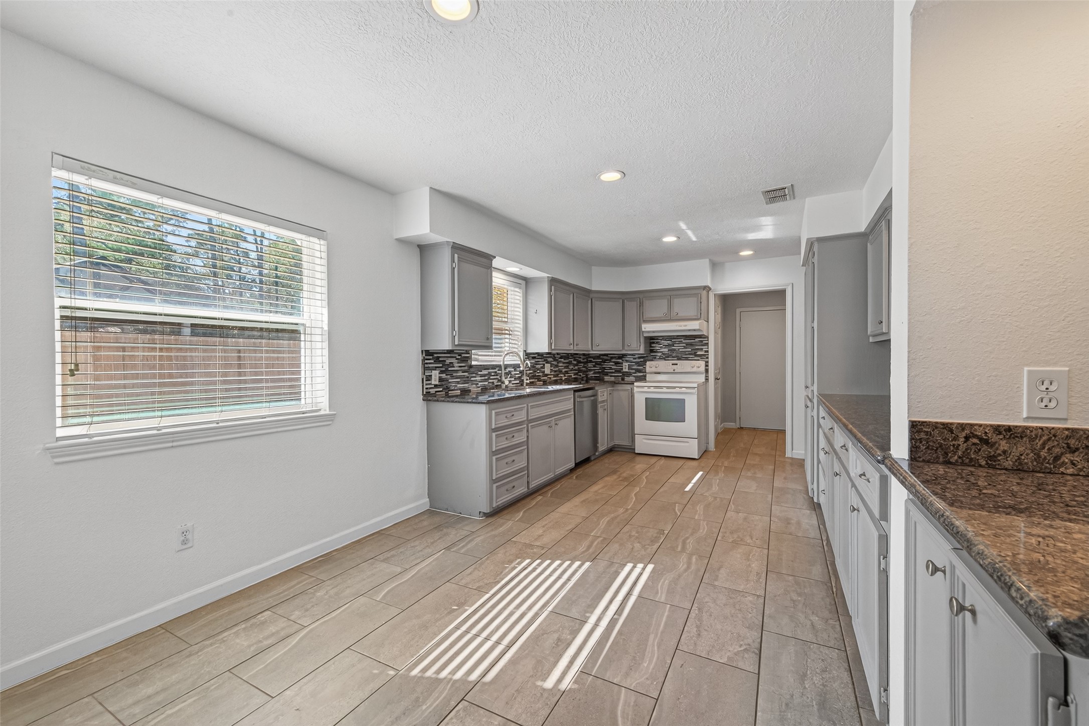 11811 Beverly Drive Houston, TX 77065 - Photo 8 of 48 Enter into the kitchen with plenty of space for a breakfast nook table, the perfect spot for that morning cup of coffee.