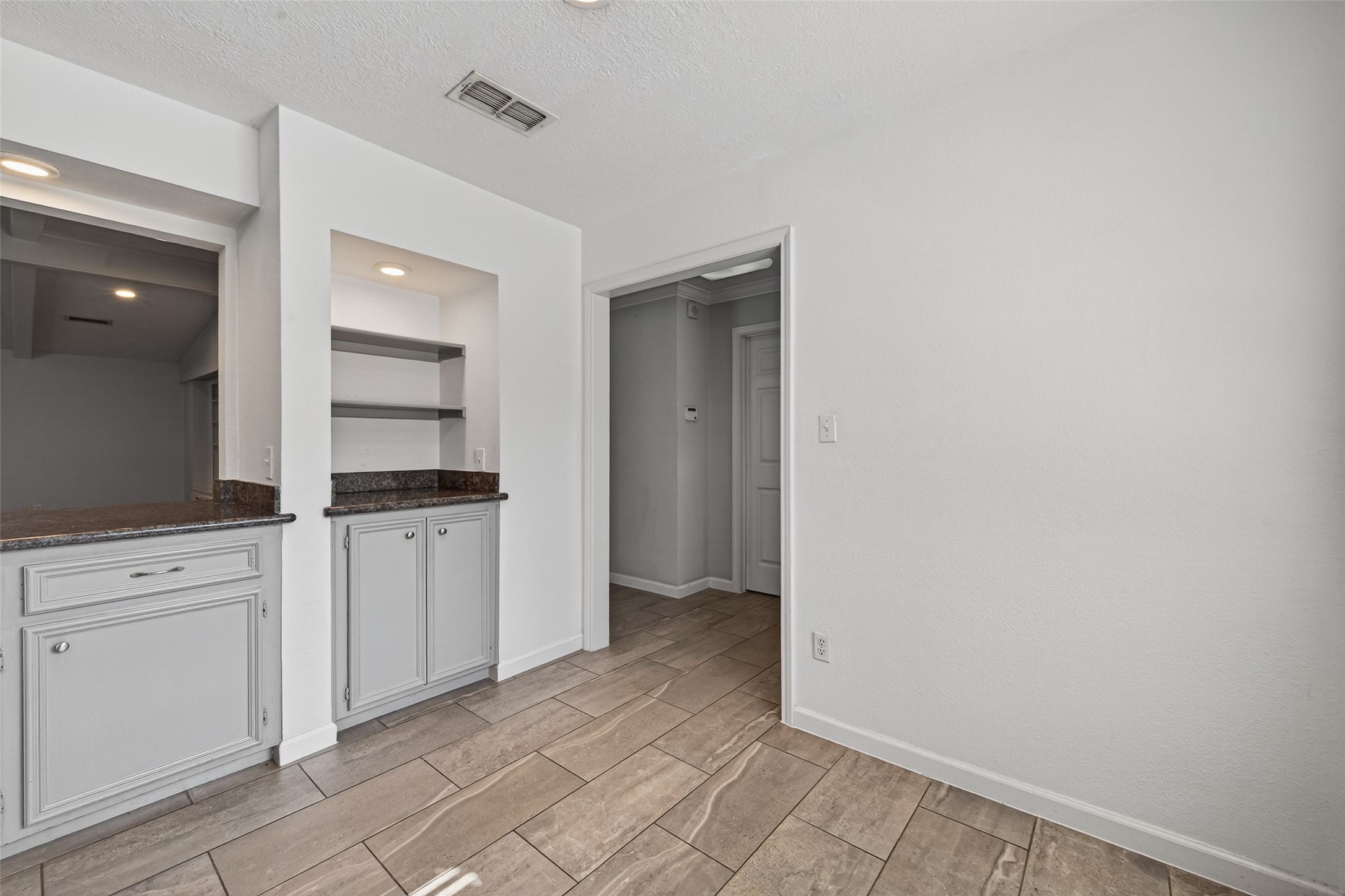 11811 Beverly Drive Houston, TX 77065 - Photo 10 of 48 a kitchen with white cabinets and white appliances