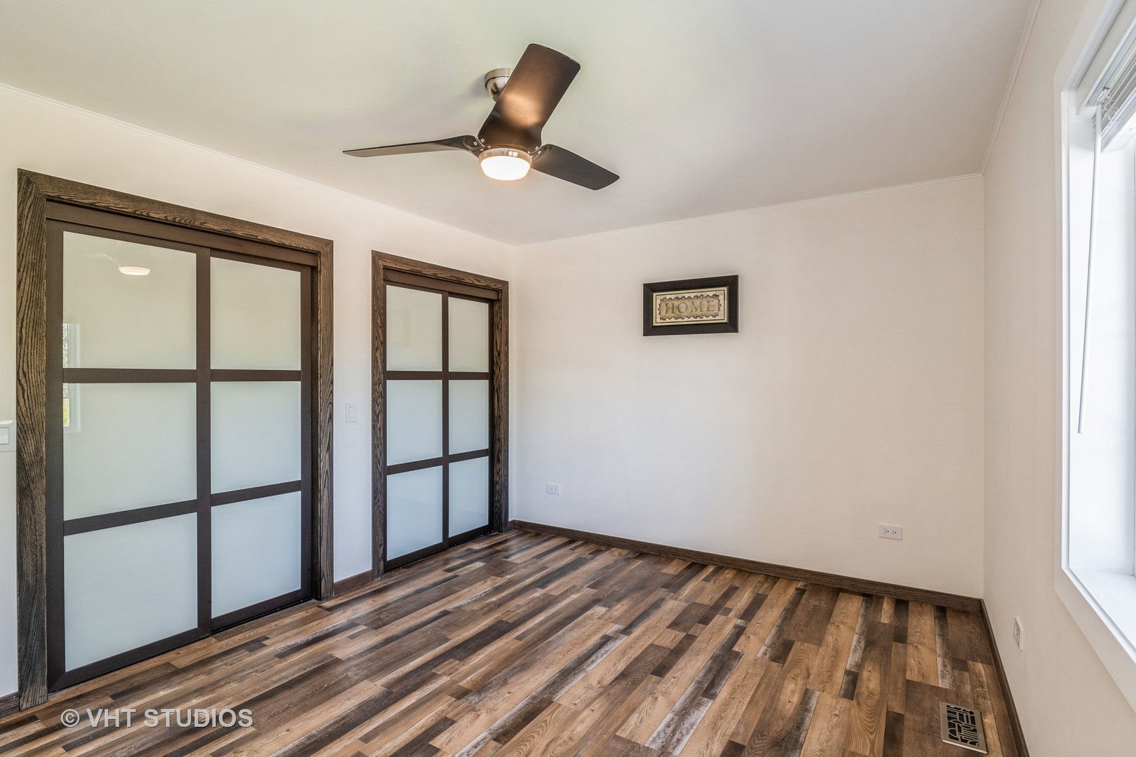336 Oak Hill Court Antioch, IL 60002 - Photo 32 of 57 a view of empty room with wooden floor and fan