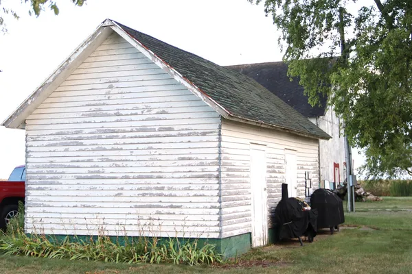 a backyard of a house with a garden and outdoor seating