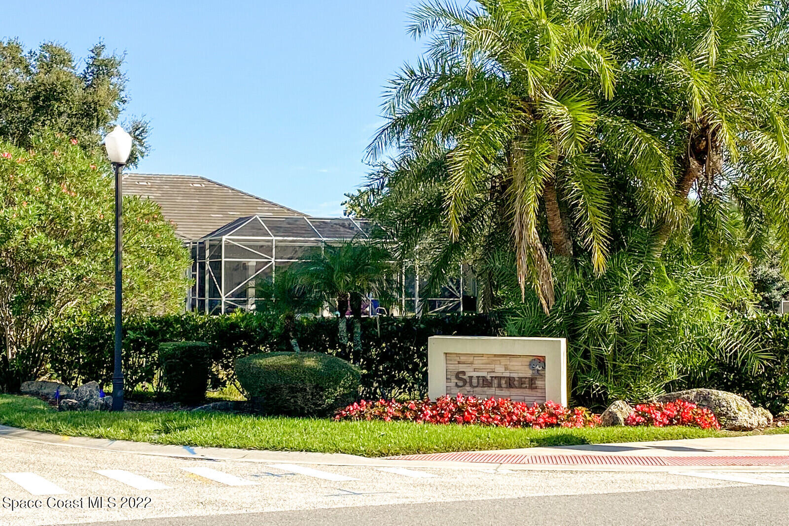 4270 Stoney Point Road Melbourne, FL 32940 - Photo 54 of 68 a front view of multi story residential apartment building with yard and sign board