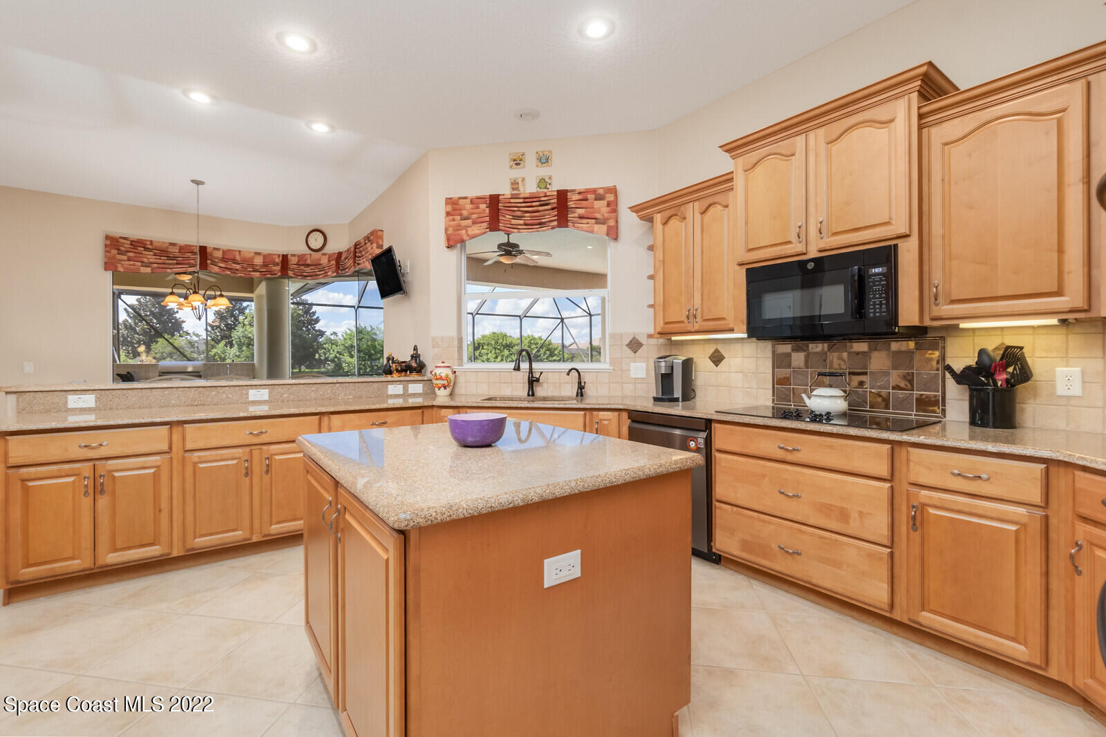 4270 Stoney Point Road Melbourne, FL 32940 - Photo 9 of 68 a kitchen with stainless steel appliances granite countertop a sink stove and cabinets