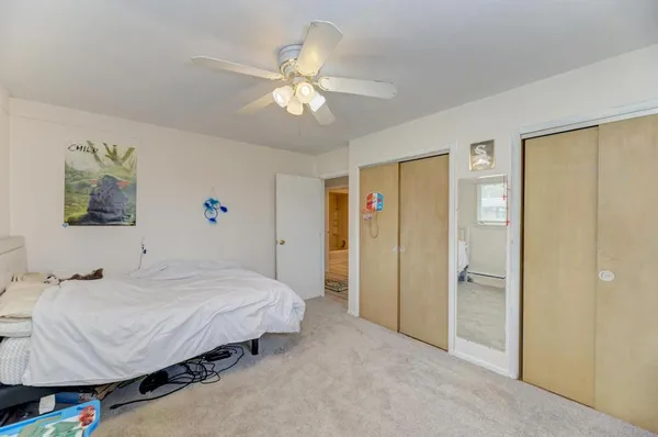 a spacious bedroom with a bed and a chandelier