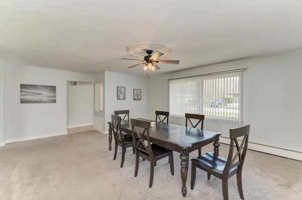 a view of a dining room with furniture and a chandelier