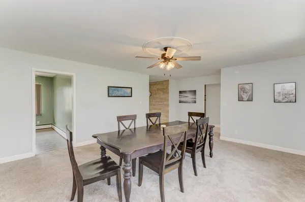 a view of a dining room with furniture and chandelier
