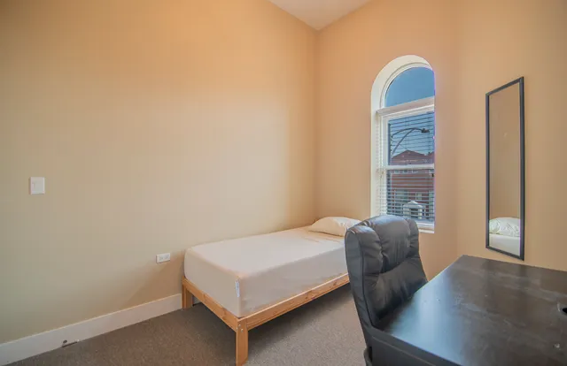 a bedroom with a bed and a window