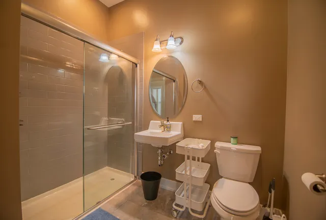 a bathroom with a toilet a sink and mirror