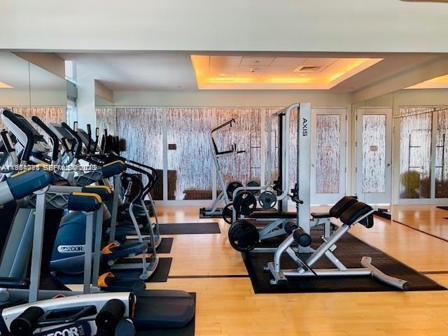 79 Southwest 12th Street, Unit 2402S Miami, FL 33130 - Photo 14 of 23 a room with gym equipment and a large window