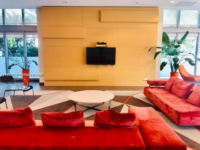 79 Southwest 12th Street, Unit 2402S Miami, FL 33130 - Photo 19 of 23 a living room with furniture and a flat screen tv