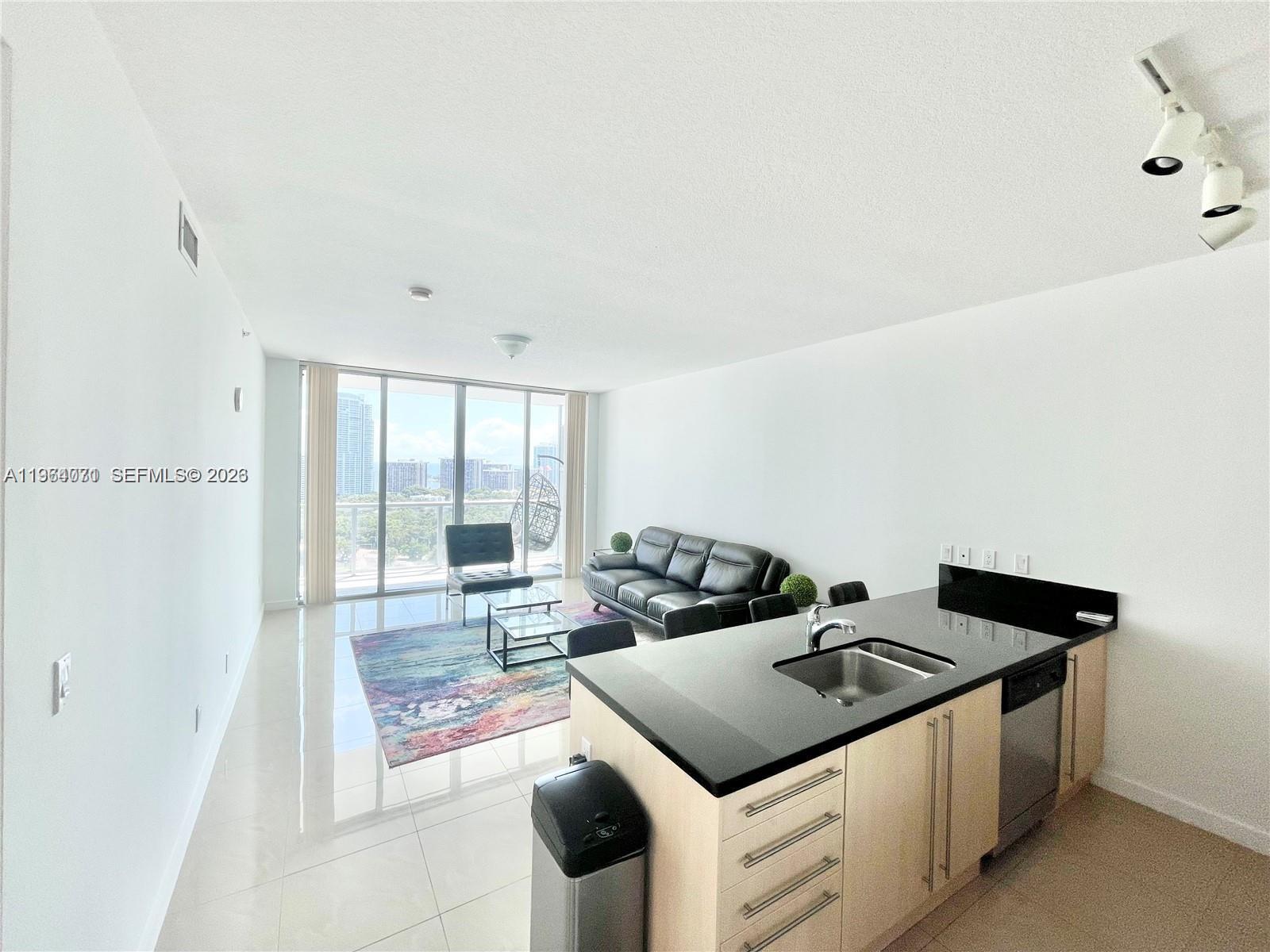 79 Southwest 12th Street, Unit 2402S Miami, FL 33130 - Photo 2 of 23 a view of kitchen with sink stove and refrigerator