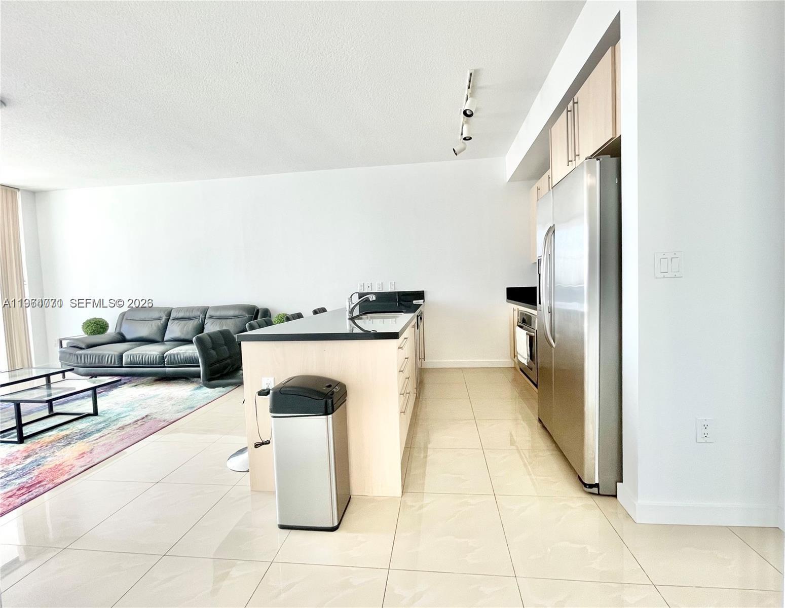 79 Southwest 12th Street, Unit 2402S Miami, FL 33130 - Photo 3 of 23 a hallway with a washer and dryer