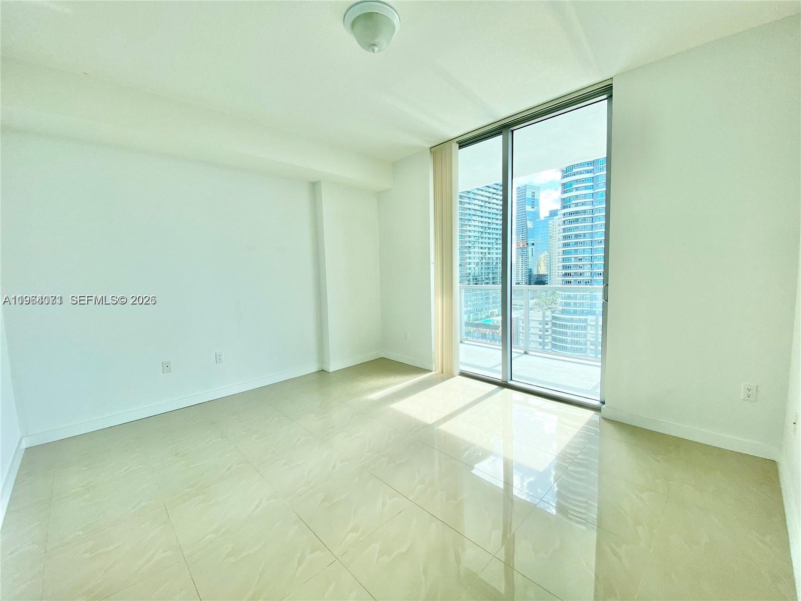79 Southwest 12th Street, Unit 2402S Miami, FL 33130 - Photo 6 of 23 a view of an empty room with glass door