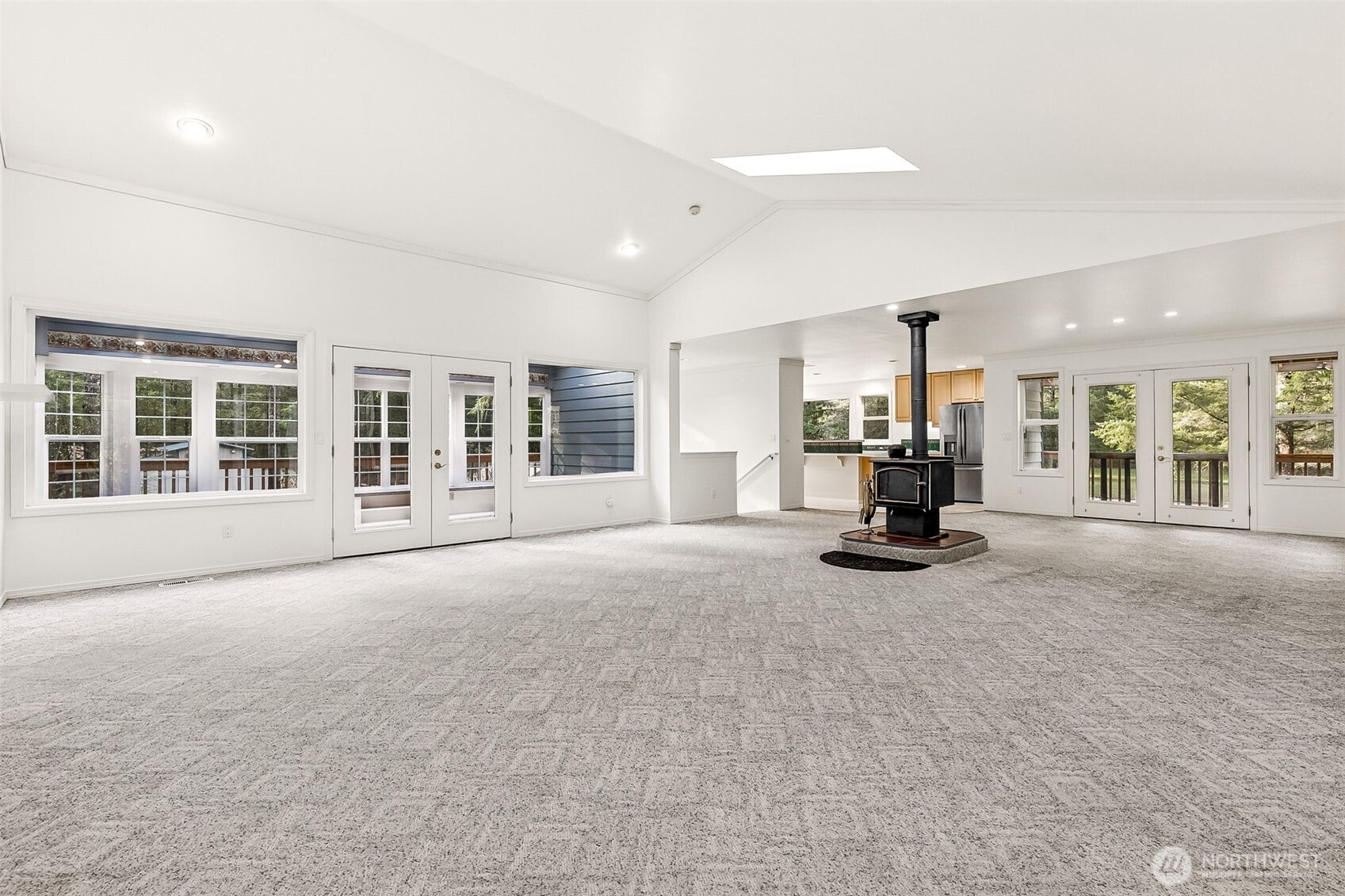 5815 95th Avenue Southwest Olympia, WA 98512 - Photo 3 of 26 a view of a livingroom with a flat screen tv and a floor to ceiling window