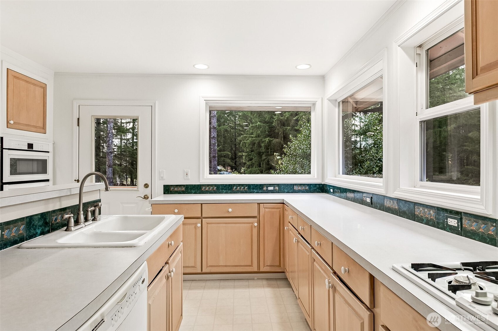 5815 95th Avenue Southwest Olympia, WA 98512 - Photo 4 of 26 a kitchen with a sink stove and cabinets