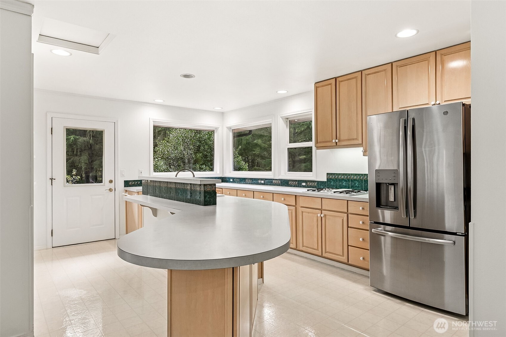 5815 95th Avenue Southwest Olympia, WA 98512 - Photo 5 of 26 a kitchen with stainless steel appliances granite countertop a refrigerator a sink a stove and island