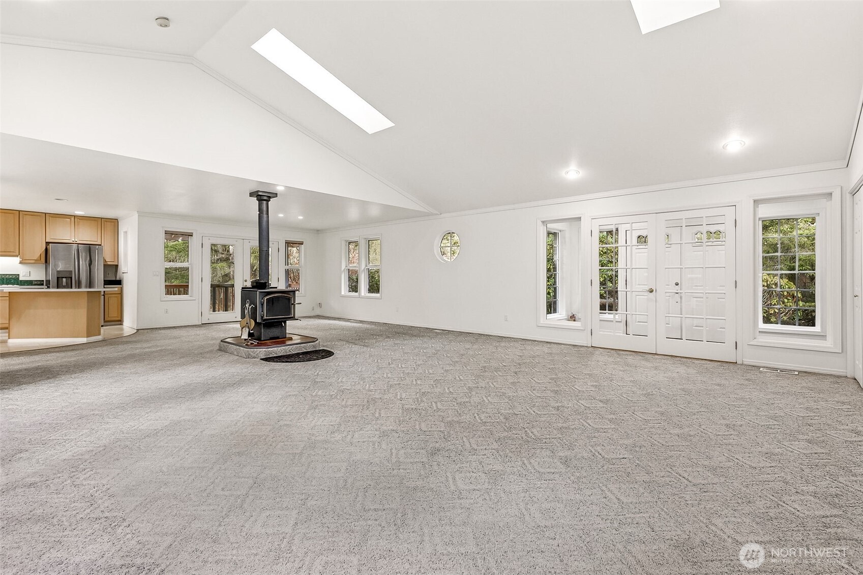 5815 95th Avenue Southwest Olympia, WA 98512 - Photo 6 of 26 an empty room with a stove and large window