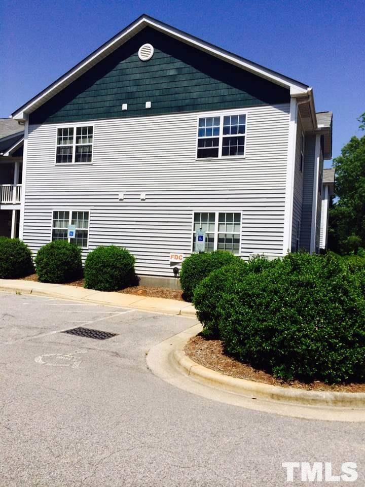 1305 Kent Road, Unit 201 Raleigh, NC 27606 - Photo 2 of 3 a front view of a house with a yard