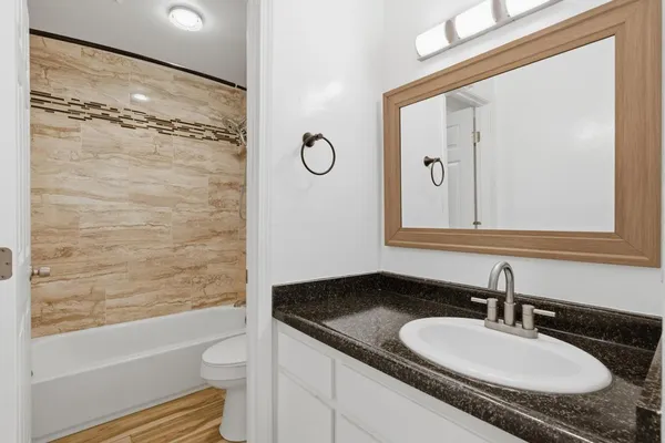 a bathroom with a shower a toilet and sink