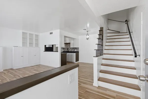 a view of empty room with wooden floor and cabinet