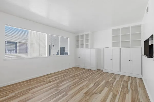wooden floor in an empty room with a mirror