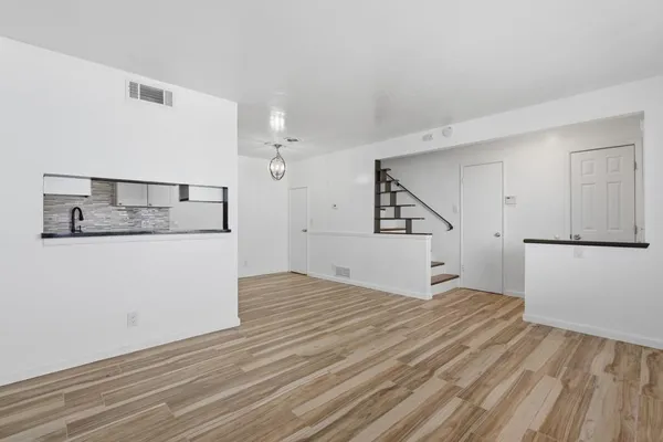 a view of empty room with wooden floor