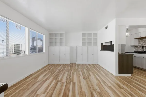 a kitchen with granite countertop a refrigerator and a stove top oven