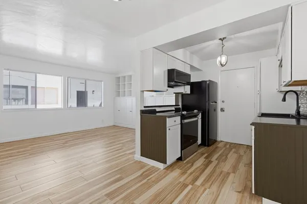 a kitchen with a sink and stainless steel appliances