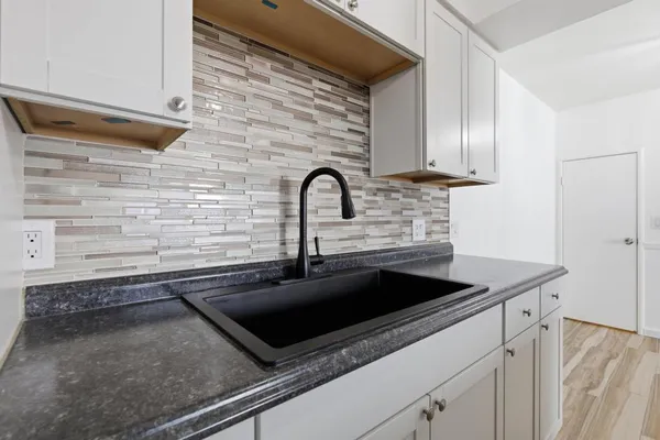 a stove top oven sitting inside of a kitchen