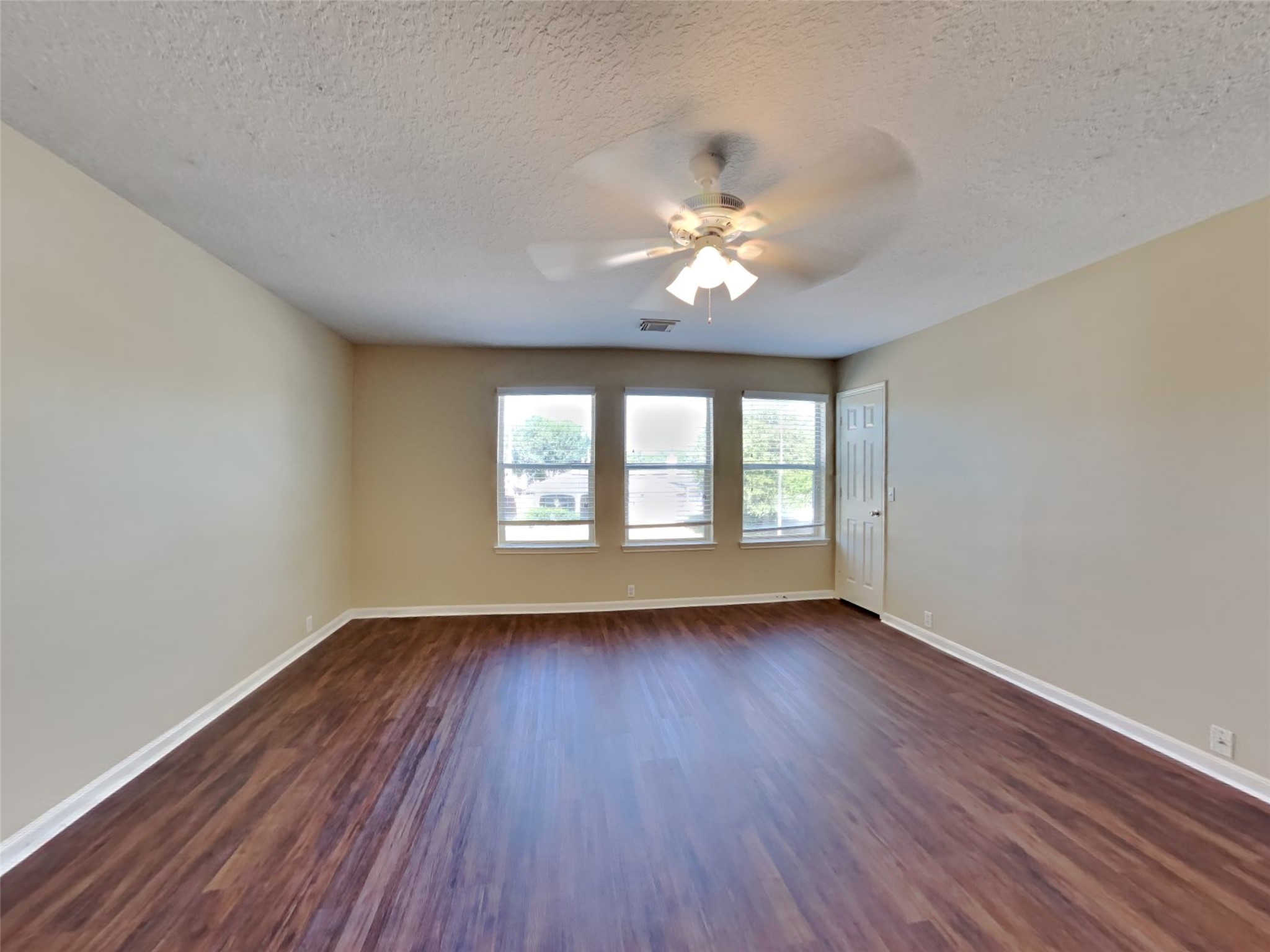 18322 Valiant Brook Court Humble, TX 77346 - Photo 5 of 20 wooden floor in an empty room with a window