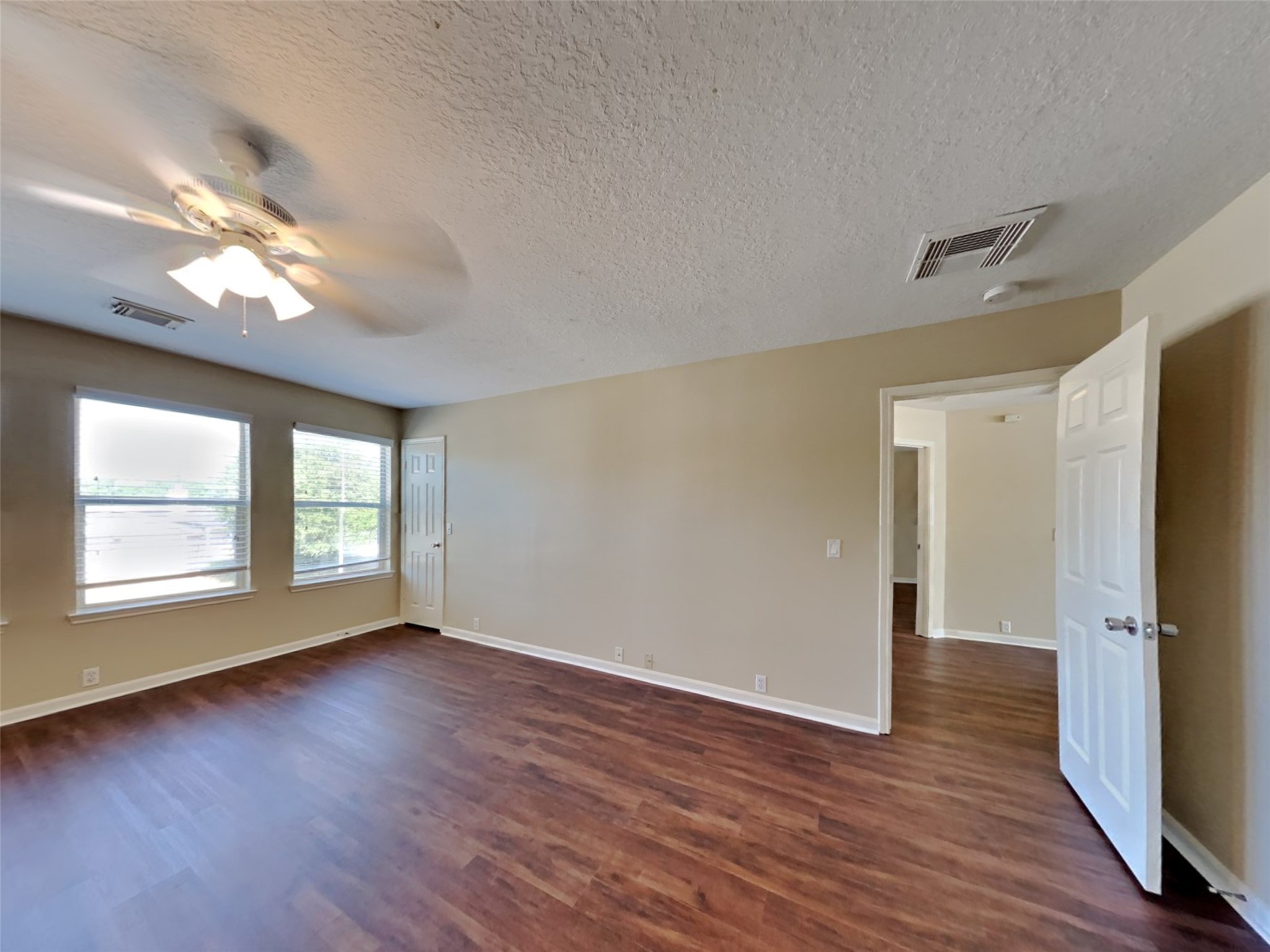 18322 Valiant Brook Court Humble, TX 77346 - Photo 7 of 20 an empty room with wooden floor and windows
