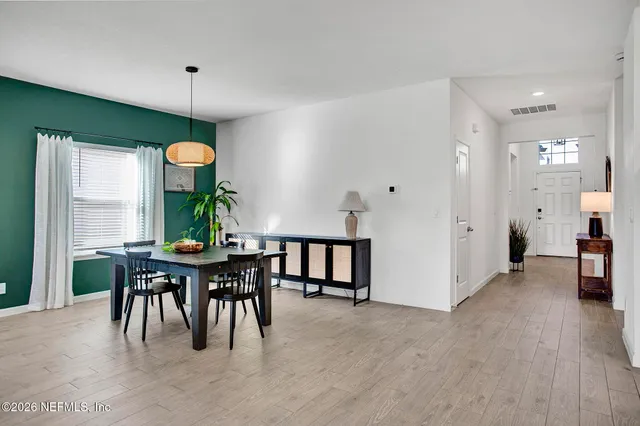 a view of a dining room with furniture window and wooden floor