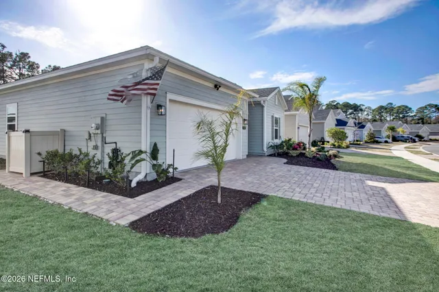 a view of a house with a porch and a yard