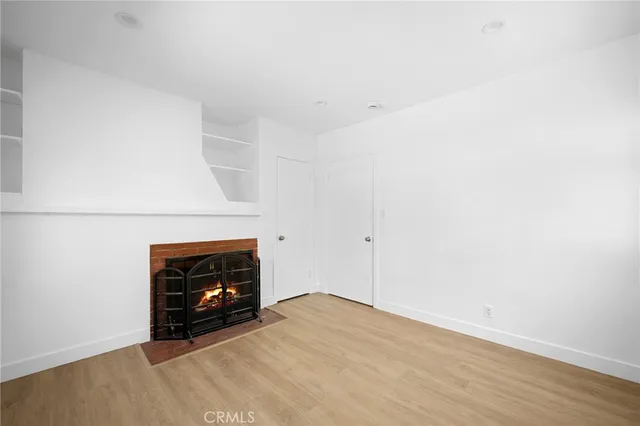 a view of an empty room with a fireplace