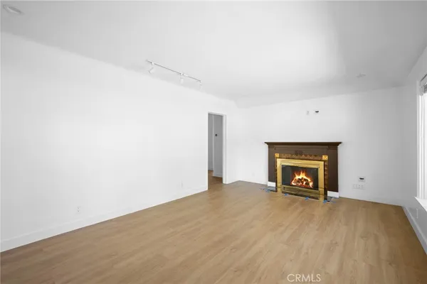 a view of empty room with a fireplace