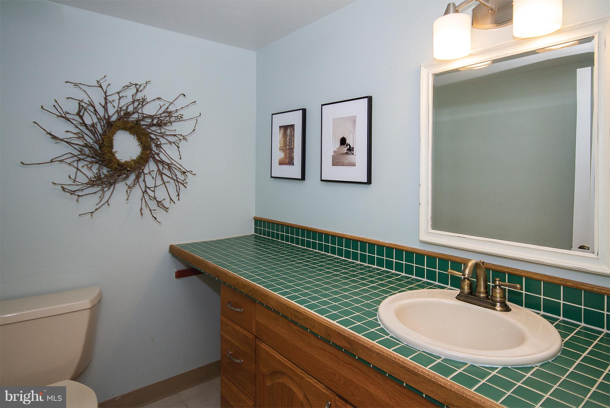 11116 Saffold Way Reston, VA 20190 - Photo 16 of 30 a bathroom with a toilet sink and mirror