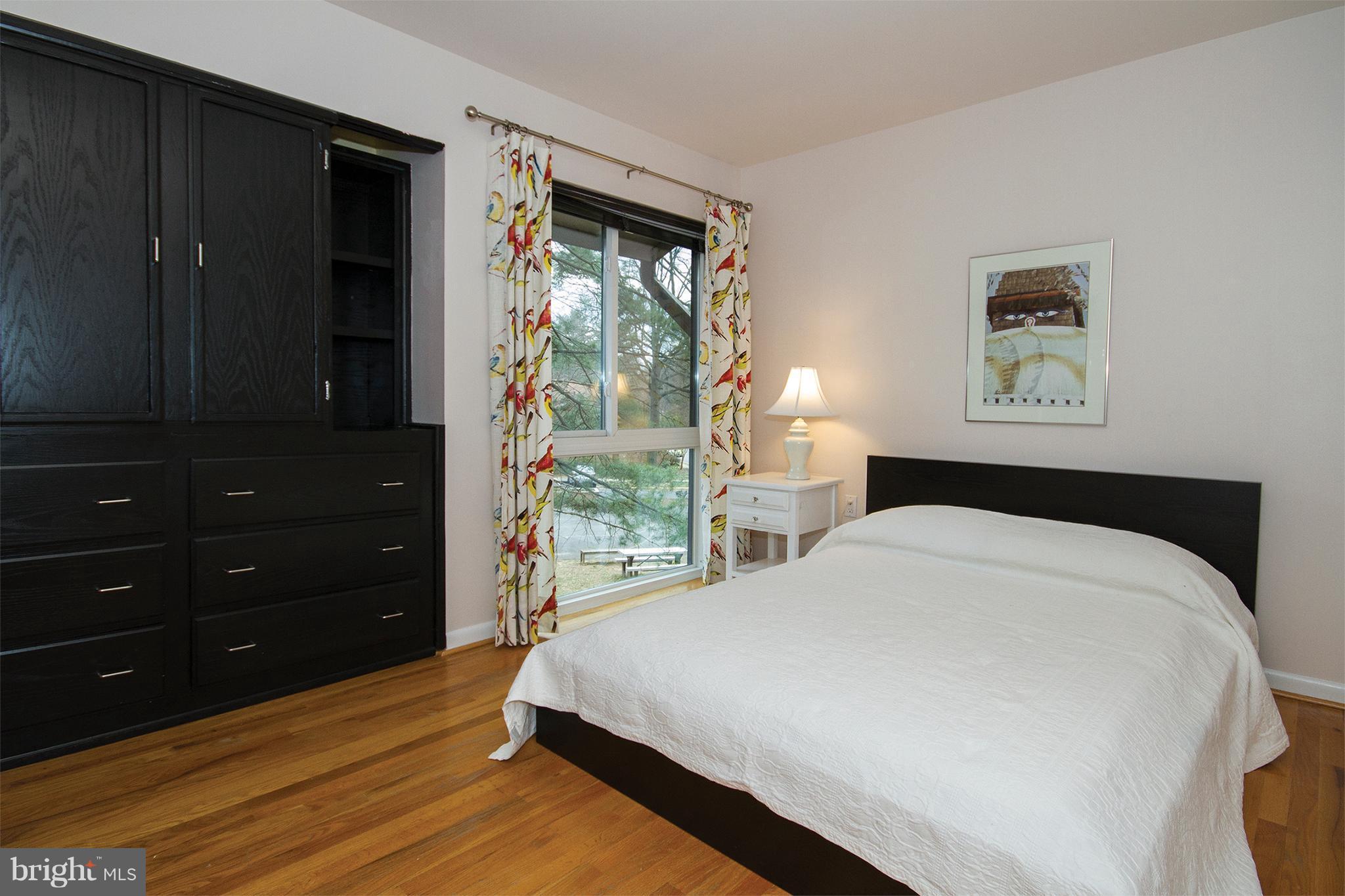 11116 Saffold Way Reston, VA 20190 - Photo 17 of 30 a bedroom with a bed and a window