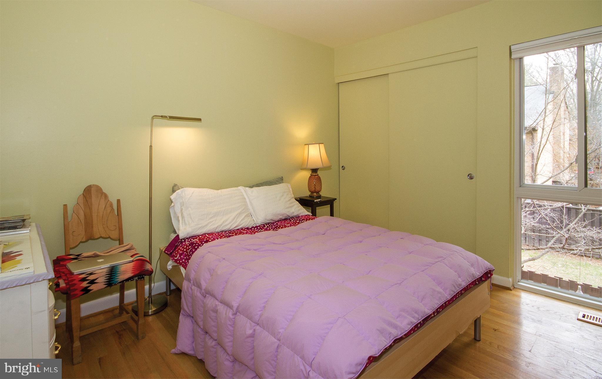 11116 Saffold Way Reston, VA 20190 - Photo 18 of 30 a bedroom with a bed a table and chair
