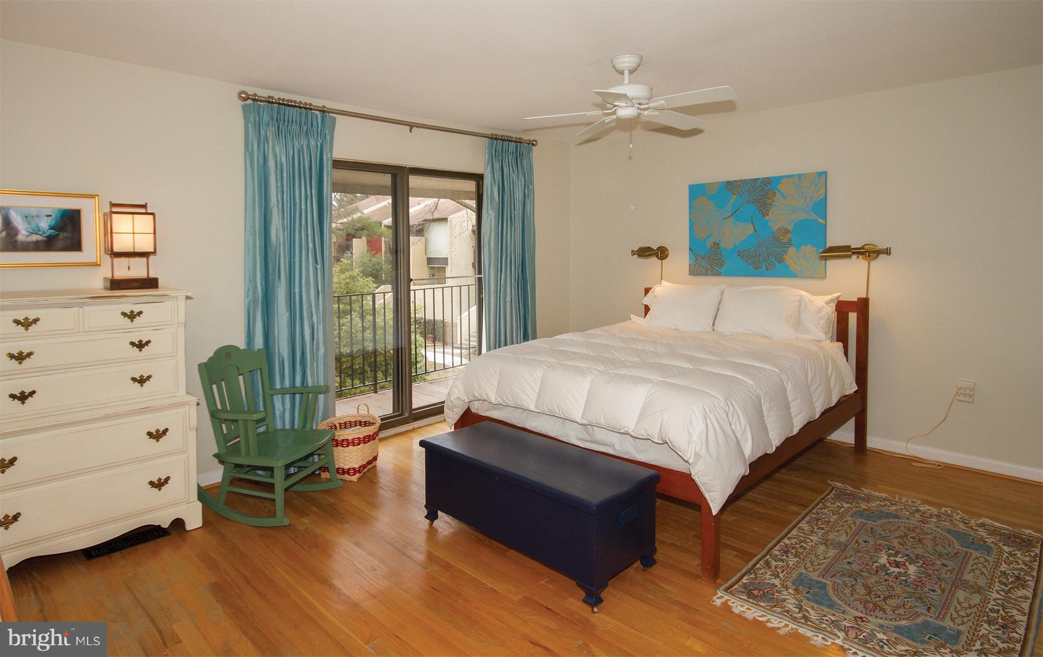 11116 Saffold Way Reston, VA 20190 - Photo 22 of 30 a spacious bedroom with a bed and a dresser