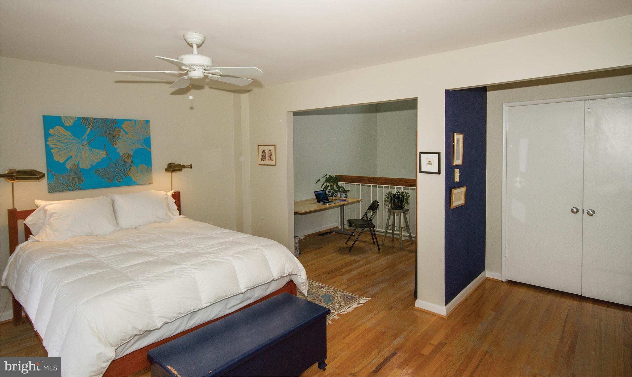 11116 Saffold Way Reston, VA 20190 - Photo 23 of 30 a bedroom with a bed and a chandelier