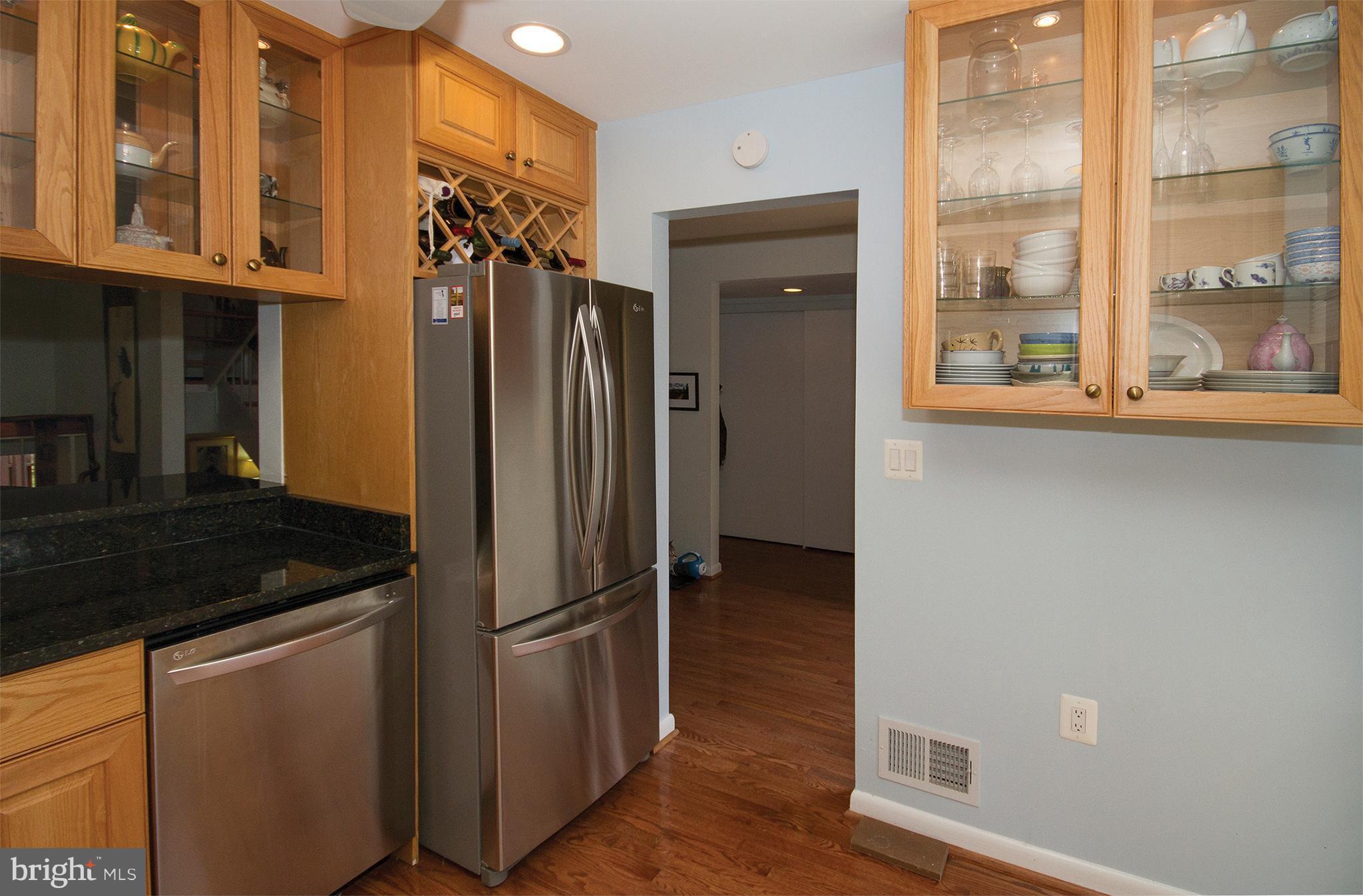 11116 Saffold Way Reston, VA 20190 - Photo 4 of 30 a kitchen with metallic refrigerator and cabinets