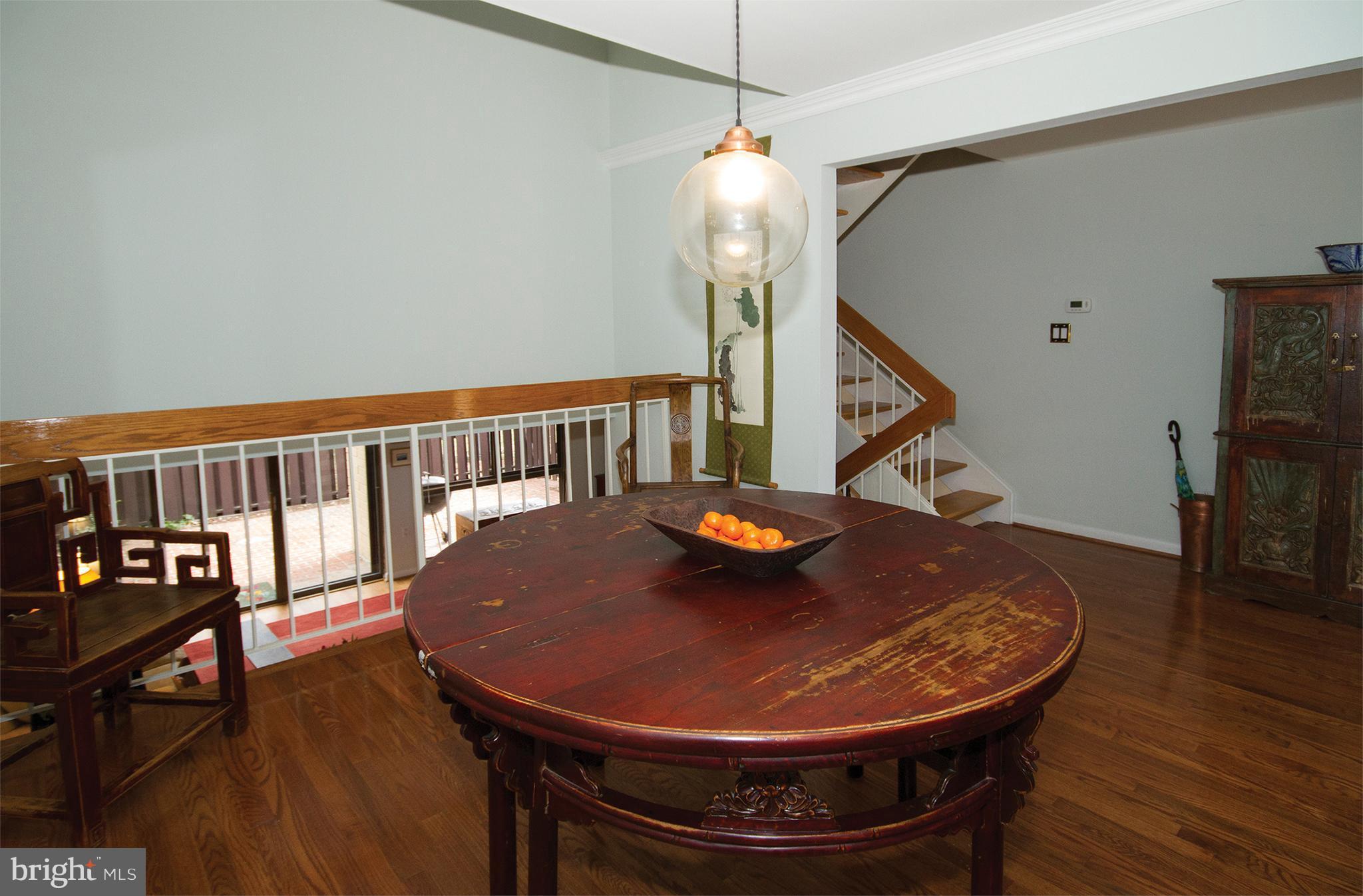 11116 Saffold Way Reston, VA 20190 - Photo 8 of 30 a view of a dining room with furniture and wooden floor