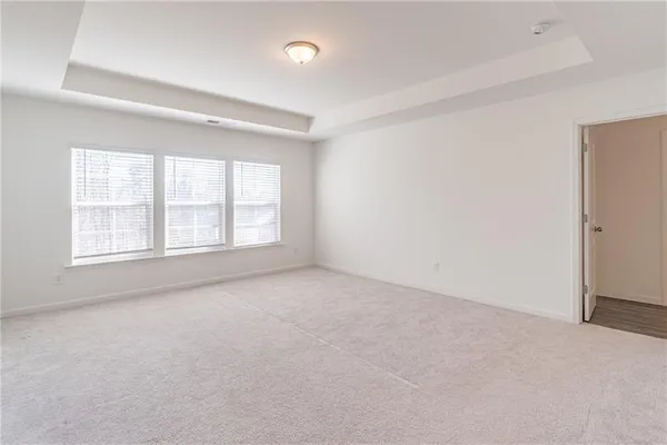 an empty room with windows and closet