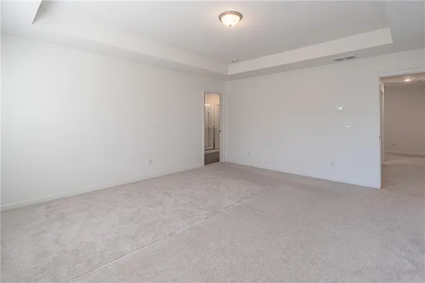 a view of an empty room and a window