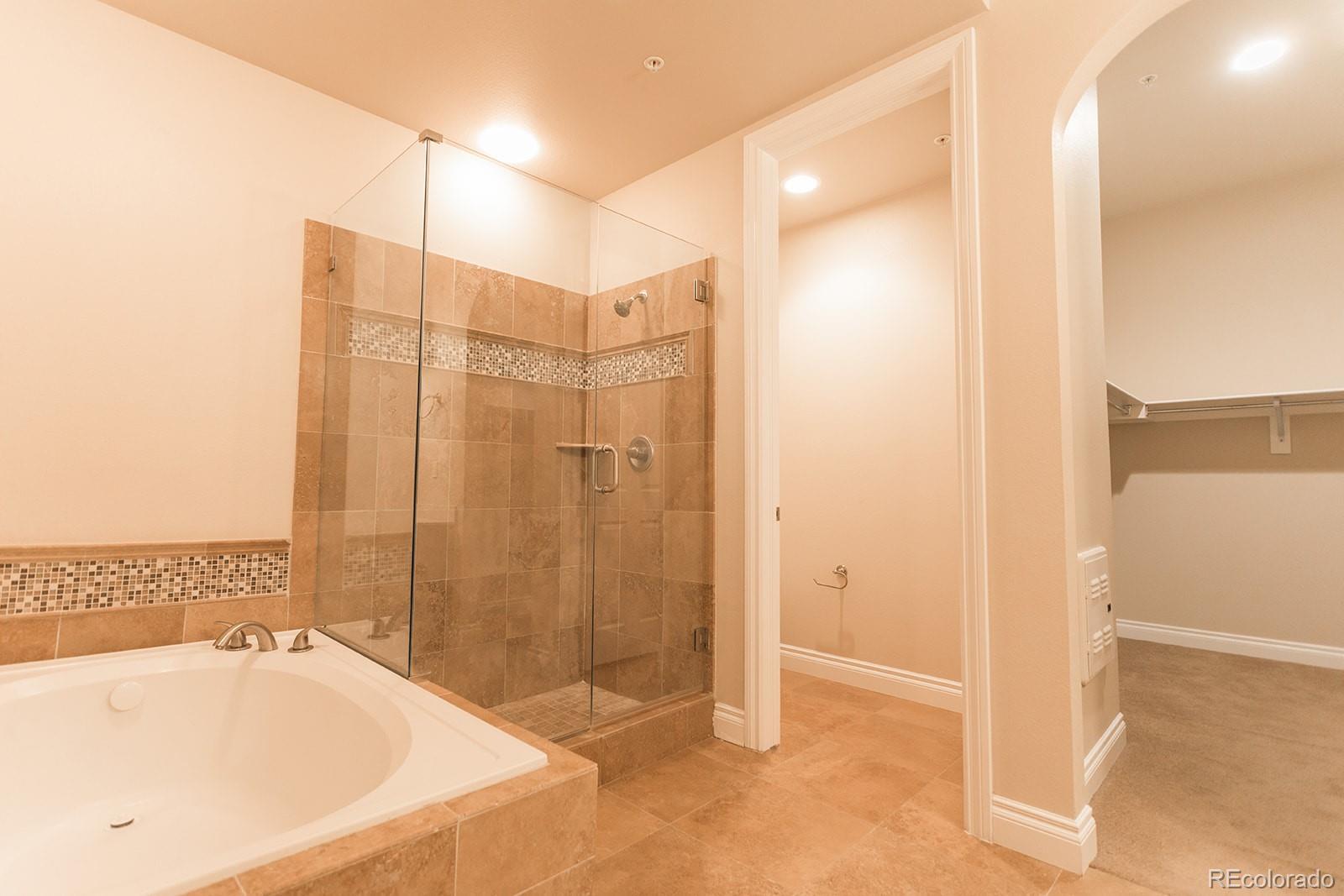 1120 Delaware Street, Unit 311 Denver, CO 80204 - Photo 13 of 25 a bathroom with a tub sink and shower