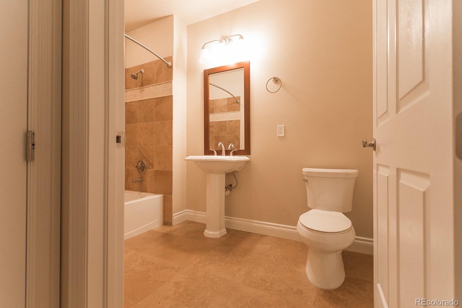 1120 Delaware Street, Unit 311 Denver, CO 80204 - Photo 17 of 25 a bathroom with a toilet